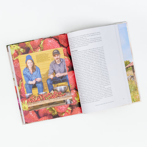 An open view of the book showing two people cutting strawberries