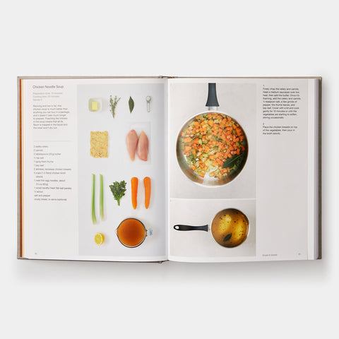 open book view of Phaidon Cookbook Simple & Classic showing a recipe, instructions, and an orderly presentation of cut ingredients