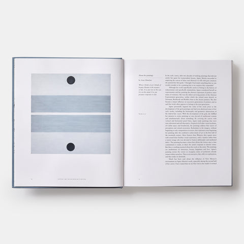 inside view of Agnes Martin book showing text and a minimalist painting of two pale blue horizontal lines and two black circles