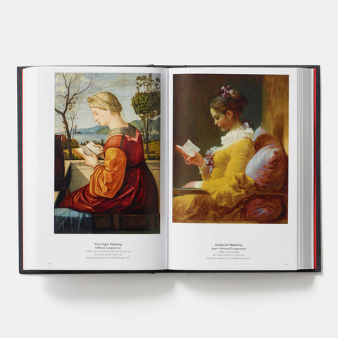 an open copy of Phaidon Book: Reading Art showing two paintings of women reading books