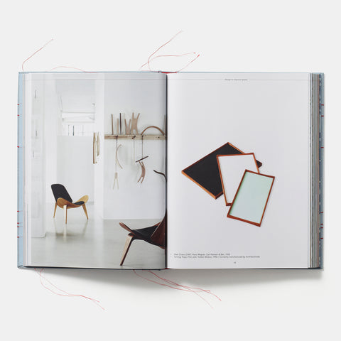 open view of The Red Thread: Nordic design showing photographs of a minimalist room with modern furniture and a stack of wooden frame mirrors