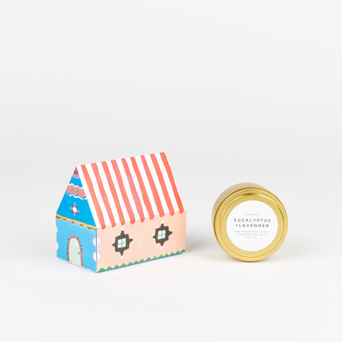 A Eucalyptus and Lavender Slow North Travel Tin Candle next to a box of State The Label House Matches