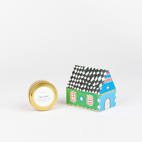 A Twilight Slow North Travel Tin Candle next to a box of State The Label House Matches