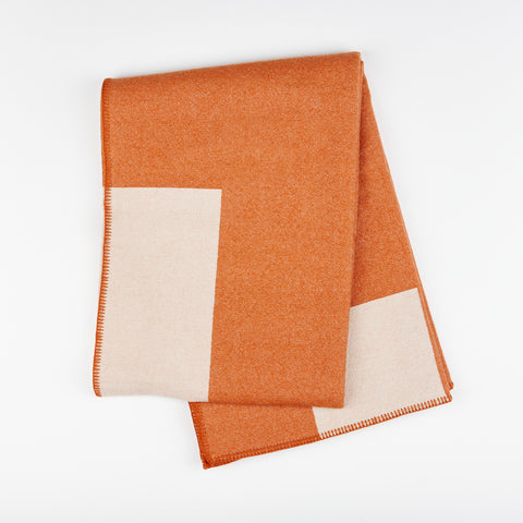 Manifatura wool throw blanket in Fox color style - burnt orange and light pink folded 