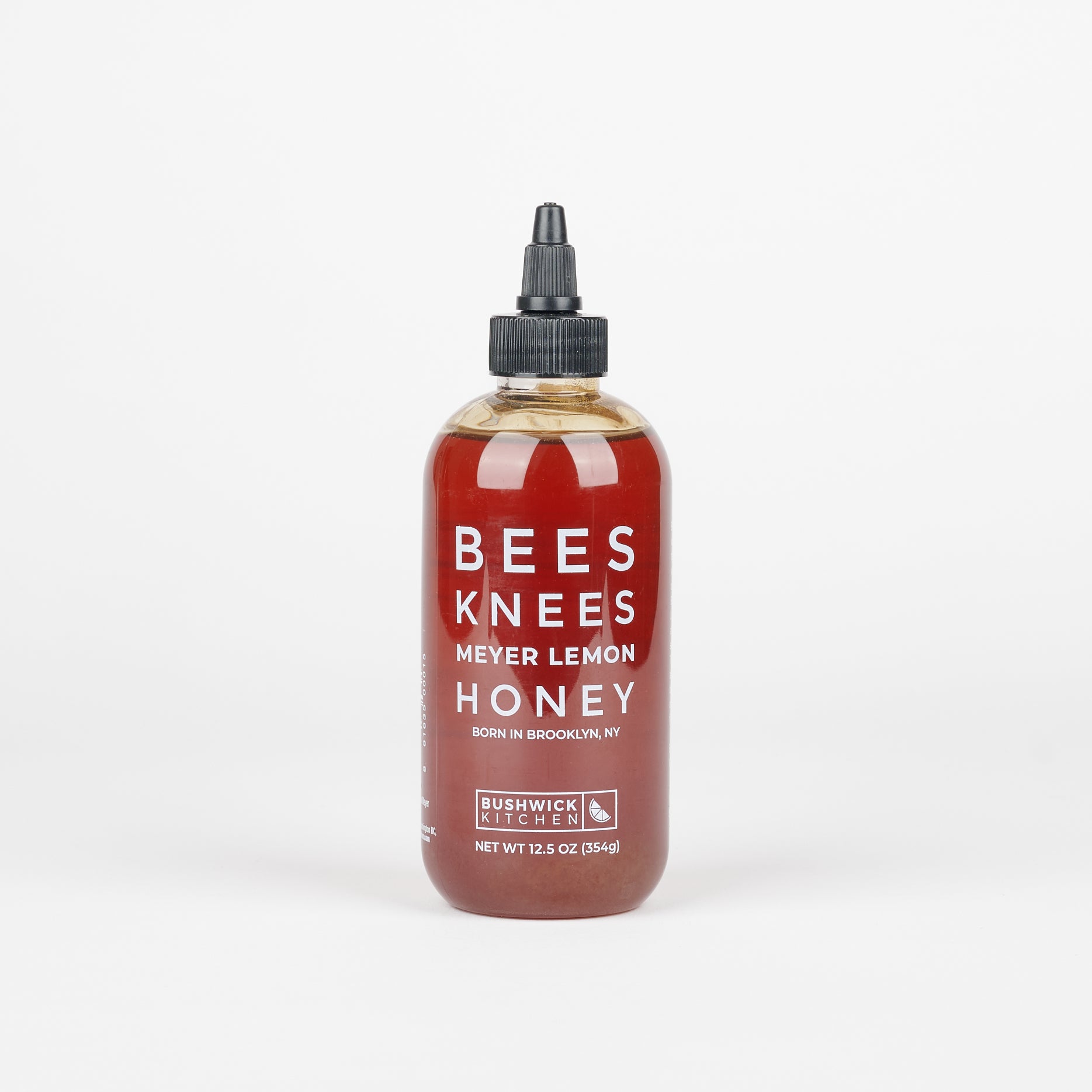 a squeeze bottle of golden amber Bees Knees Meyer Lemon Honey