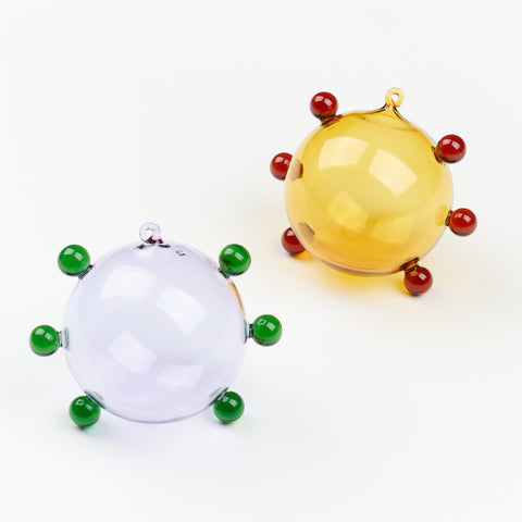 Two colorful circular glass ornaments with small glass dots around the edges