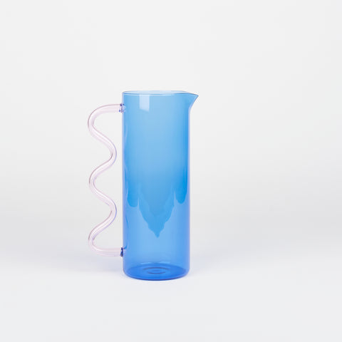 Blue glass pitcher with pink handle by Sophie Lou Jacobsen