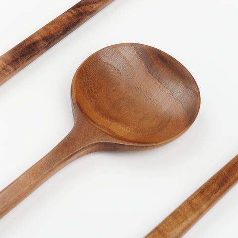 a detail view of the wood grain of a walnut cooking spoon