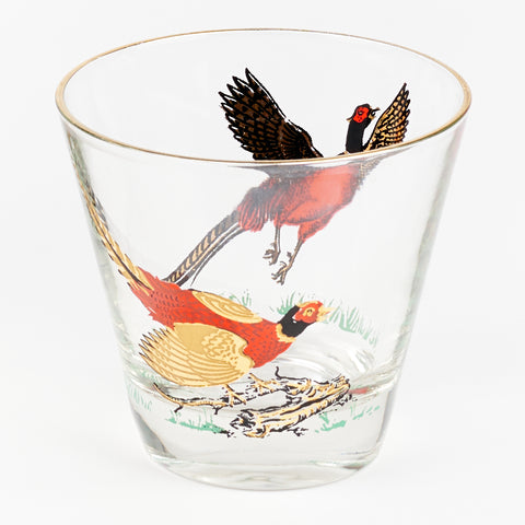 close up of a vintage Manhattan cocktail glass with pheasants on two sides of the glass