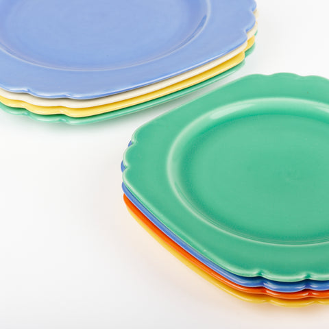 two stacks of multi-colored Riviera Ware Ceramic plates