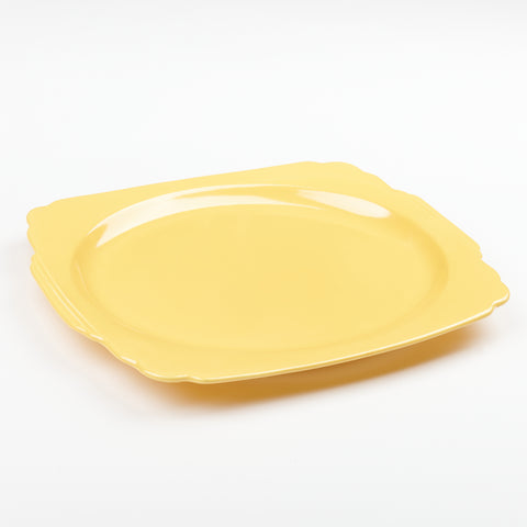 a large yellow Riviera Ware Ceramic serving dish that is relatively flat but large in shape