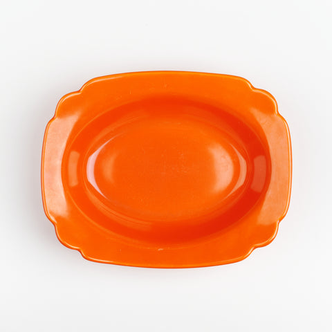 A bright red vintage serving dish with rounded edges