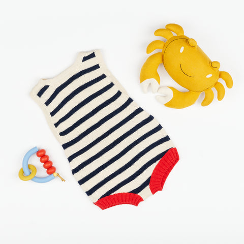 striped knit baby romper with teething ring in primary colors and a plush soft toy yellow crab with white claws