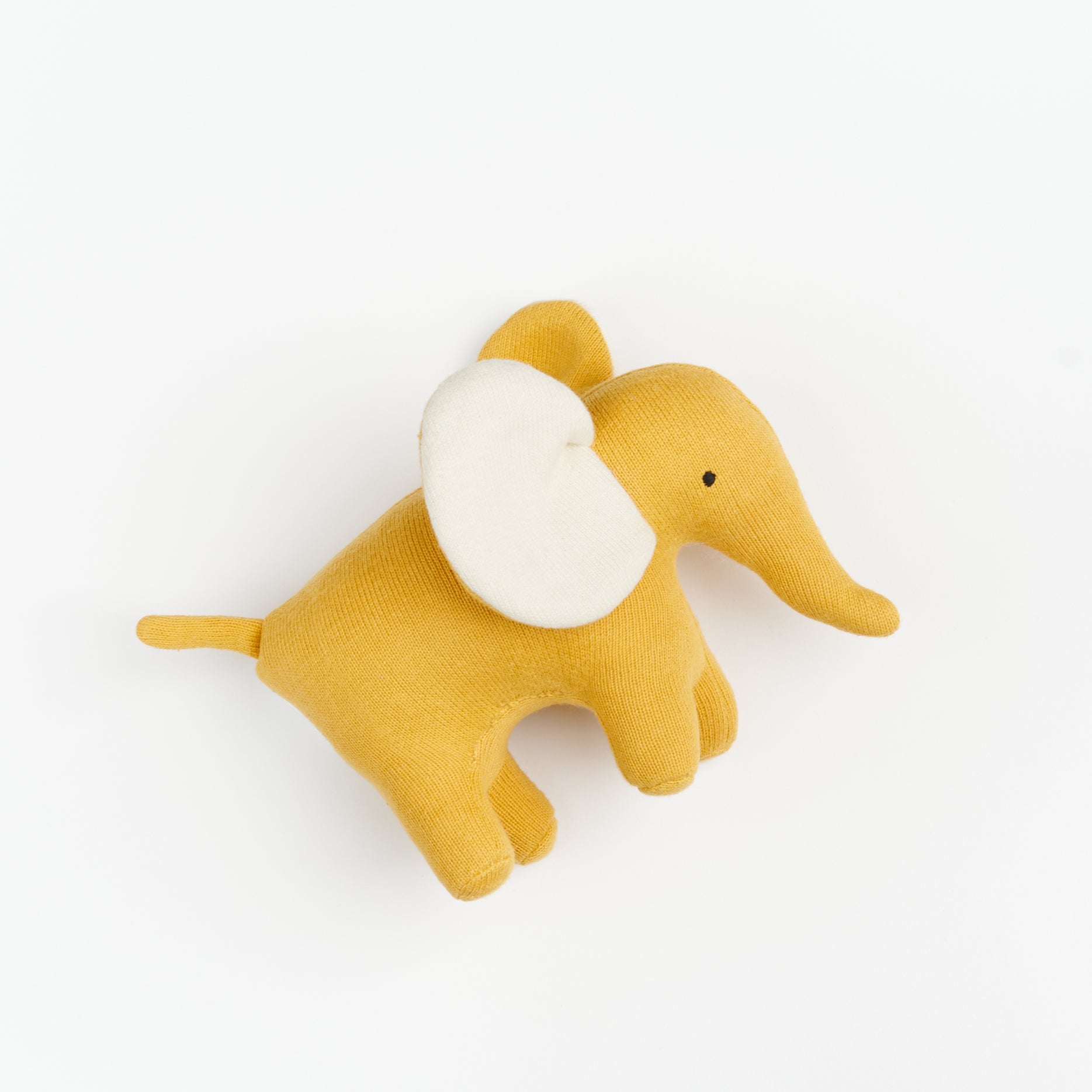 A small plush soft toy elephant with yellow body, tail and trunk and white insides of cute floppy ears