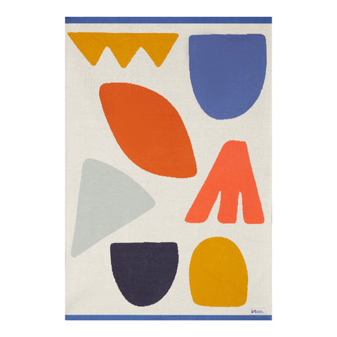 A baby blanket with large colorful abstract shapes and a blue trim