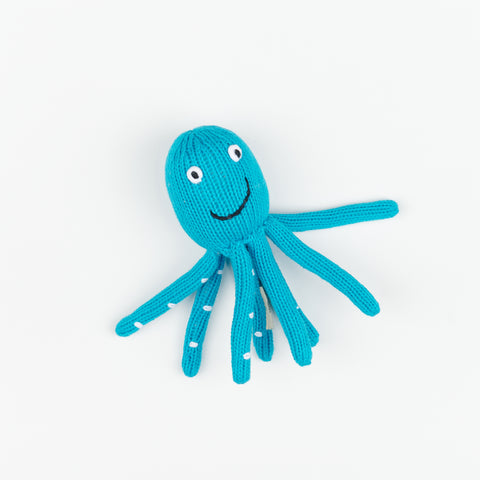 A plush electric blue knitted octopus baby rattle with a smiling face