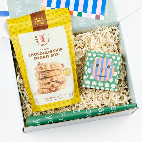 an open gift box featuring chocolate chip cookie mix and a kitchen timer