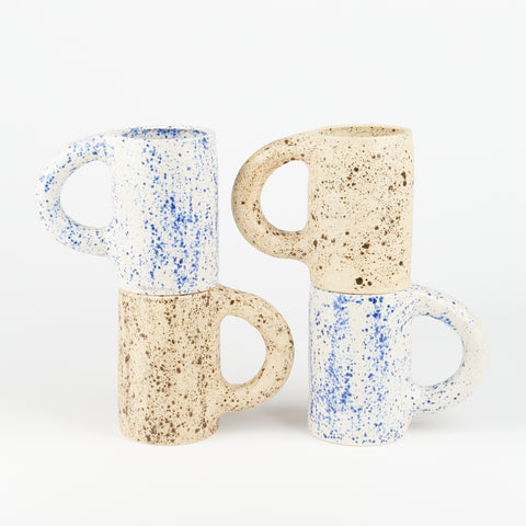four large blue and eggshell speckled Utility Objects ceramic Nagai mugs stacked two on top of two with the handles pointing in opposite directions