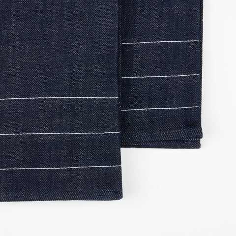 close up detail of a pair of denim tea towels with decorative white stitching lines
