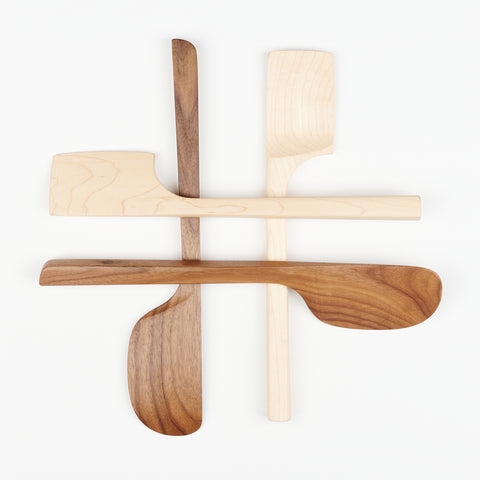 four wooden spatulas arranged in a hashtag formation