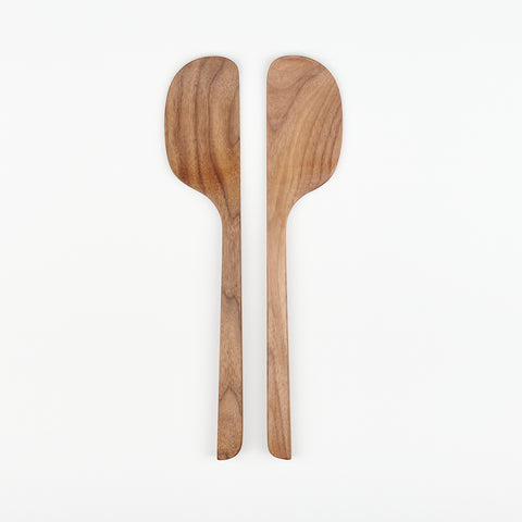 a pair of two Bad Dogs Studio walnut wooden spatulas