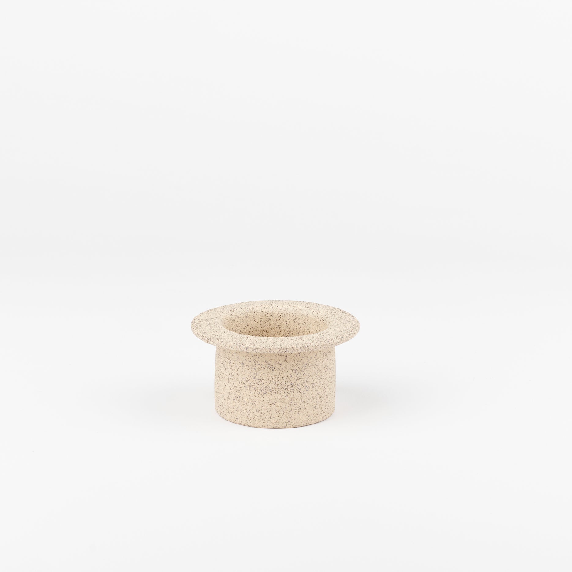 a sand colored ceramic tea strainer handmade by Utility Objects standing up