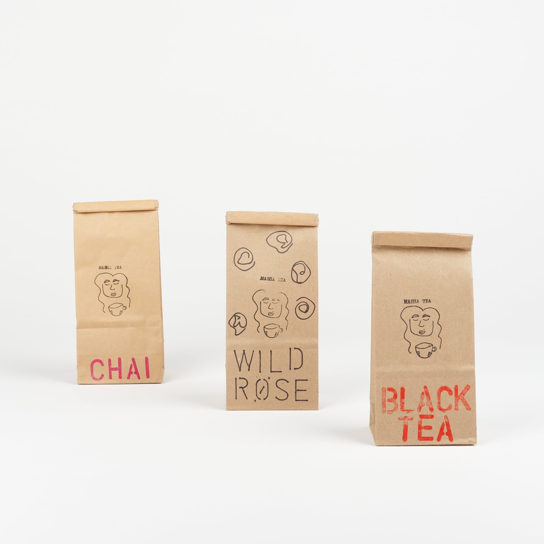 three brown bags of Masha loose leaf tea flavors Chai, Wild Rose, and Black tea