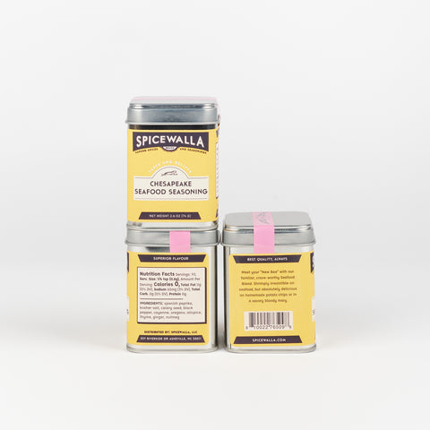 three tins of Spicewalla Chesapeake Seafood Seasoning with bright yellow labels arranged in a L shape