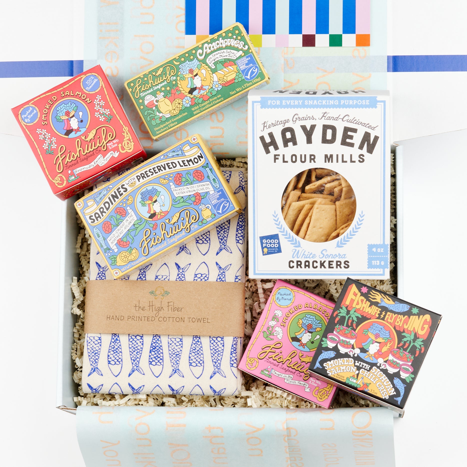 An open CETTE gift box showing the Seaside Snack Tinned Fish Gift Set