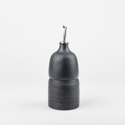 A black olive oil cruet made by Utility Objects