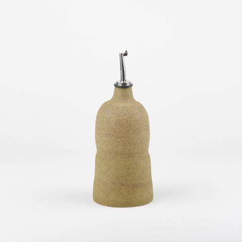 An olive colored handmade ceramic oil cruet by Utility Objects