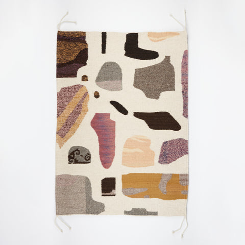 Image of Amanda Barr woven rug with a cream background and a pattern of stones