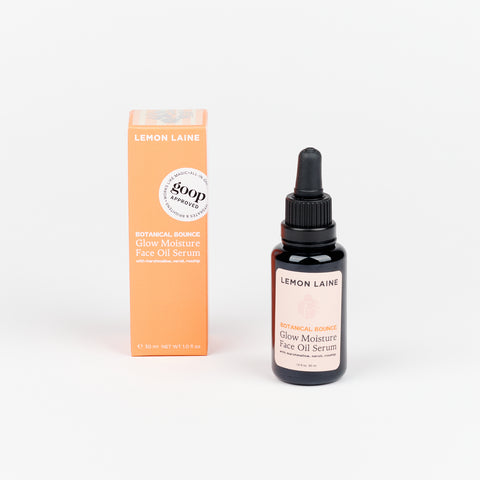 Dropper bottle of Lemon Laine Glow Moisture Face Oil Serum on a white background, with an apricot-color box next to it.