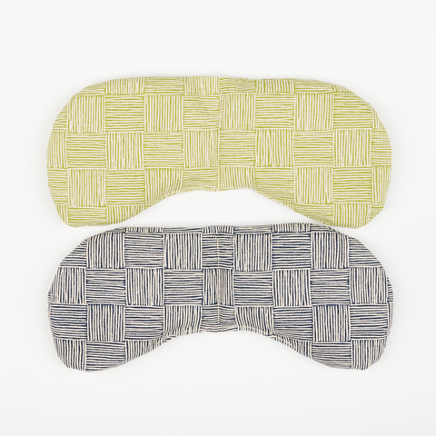 two eye masks one with a green crosshatch pattern and the other with a gray crosshatch print