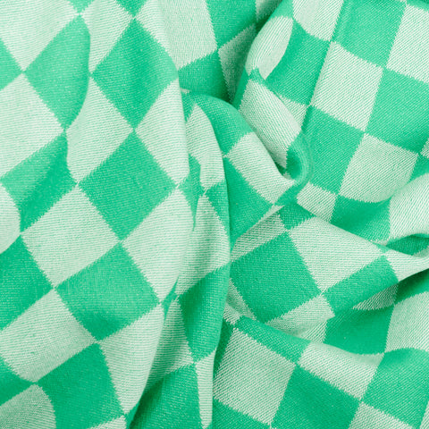 a close up of the folds of green checkerboard Turkish bath towel