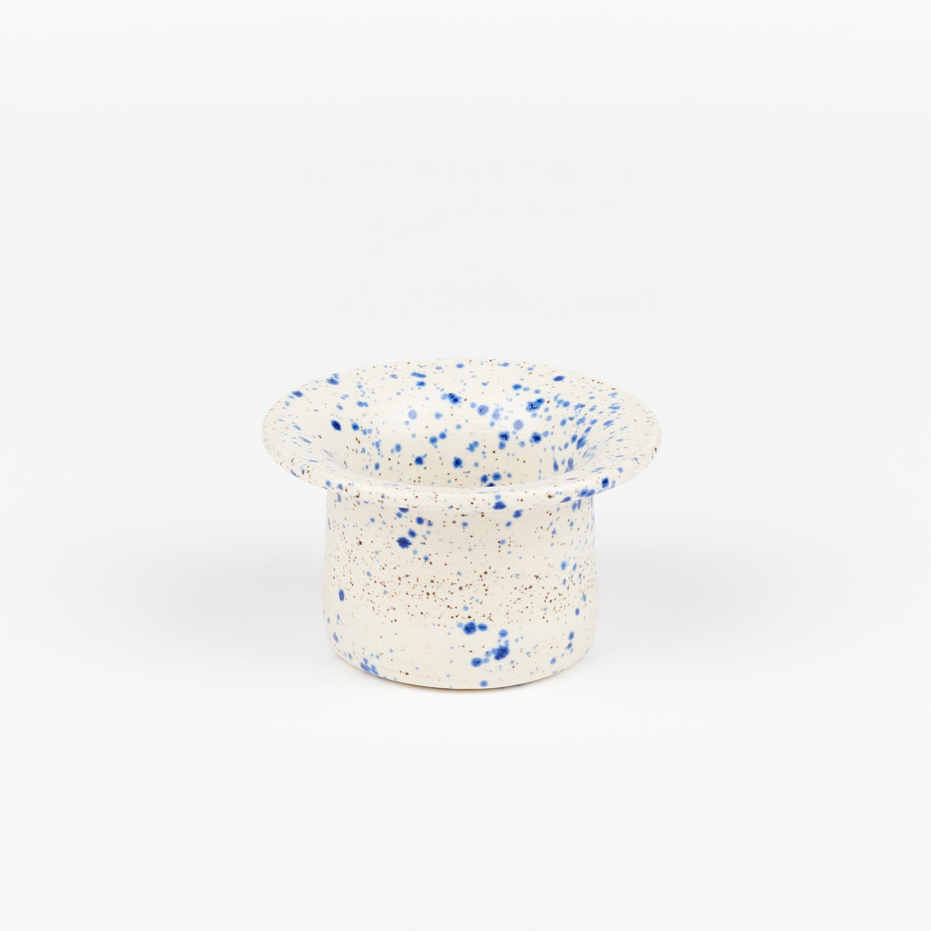 a Utility Objects Blue Speckle tea strainer standing up