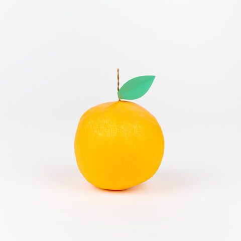 A TOPS Malibu surprise ball that is made to look like an orange with a green paper leaf on a metal stem