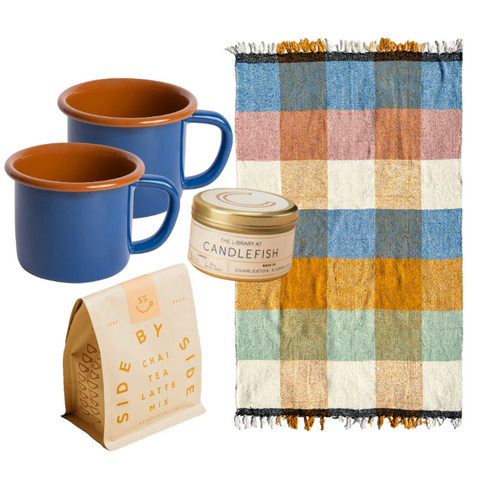Kindled Comfort gift set items—handwoven plaid blanket, two enamelware mugs, chai tea, and travel tin candle—displayed together on white background.