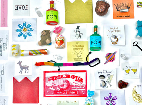 Assorted mini toys and trinkets that can be found inside the surprise balls shown on a white background