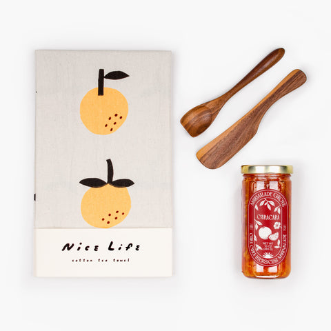 Jam On It gift set contents arranged in flat lay: marmalade jar, folded tea towel, and walnut spreaders—ideal for thank you and host gifts.