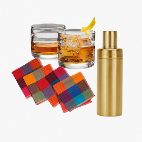 The Main Event gift set with handblown glass tumblers, brass cocktail shaker, and checkered cocktail napkins in Fruit Salad colorway on a white background.