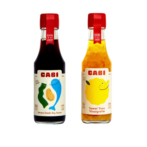 Front view of Cabi Yuzu Vinaigrette and Cabi Dashi Soy bottles side by side.