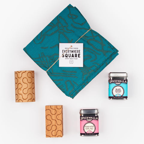 Shake It Up gift set with Jenny Pennywood Everywhere Square textile in teal, Dusen Dusen wooden salt and pepper shakers, and Spicewalla spices.