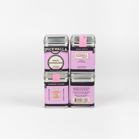Stack of purple Spicewalla white peppercorn tins