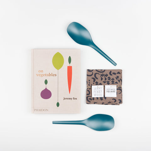 A Cookbook set including Blue Abyss EKOBO bamboo serving spoons, Phaidon Cookbook - On Vegetables by Jeremy Fox, and a Jenny Pennywood Everywhere Square in walnut and midnight