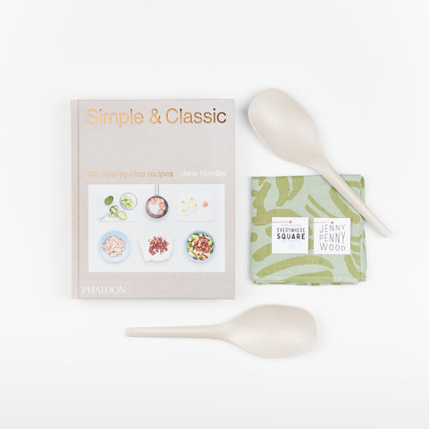 A Cookbook set including EKOBO bamboo serving spoons in stone color, Phaidon Cookbook - Simple and Classic 123 step by step recipies, and a Jenny Pennywood Everywhere Square in sage and matcha