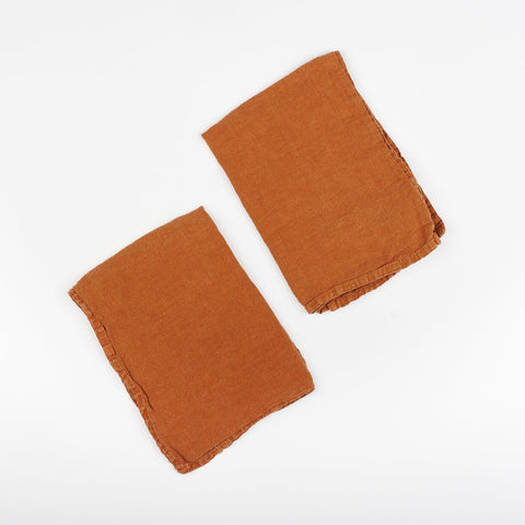 Set of rust orange Hawkins New York linen napkins